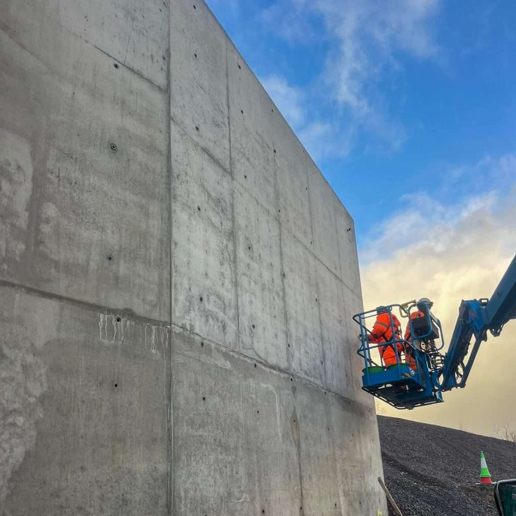 Carney Construction team repairing a concrete wall, ensuring structural integrity.